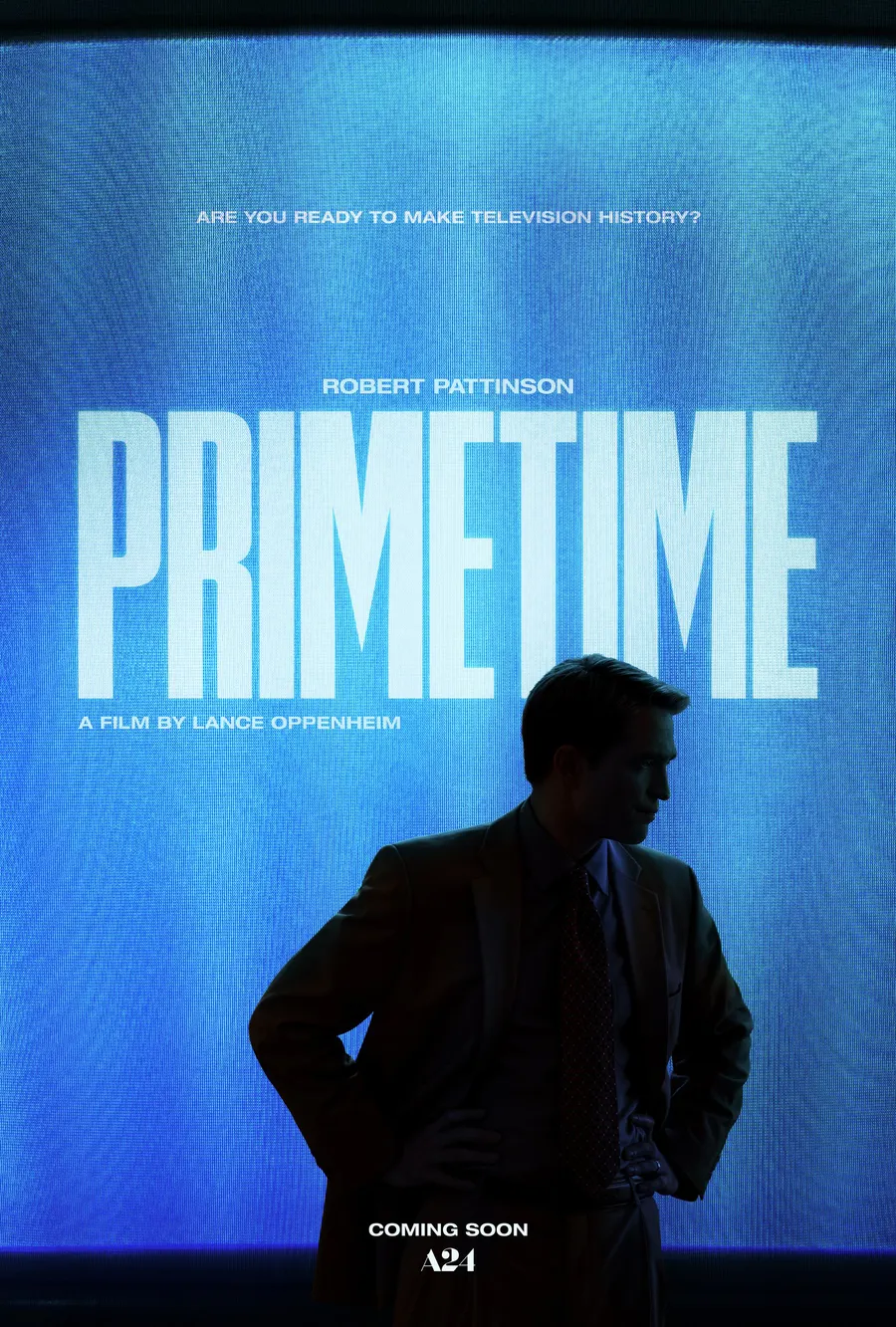Official teaser poster — Robert Pattinson silhouetted before a glowing blue screen reading PRIMETIME.